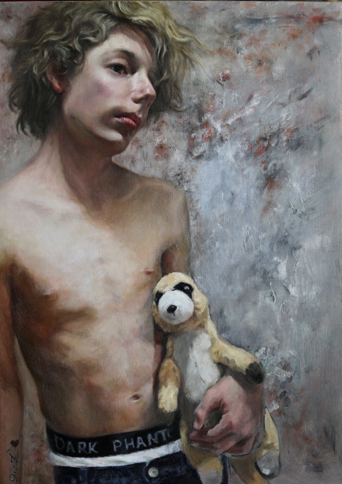 A teenage boy holding a childhood stuffed animal, wearing 'Dark Phantom' boxer shorts